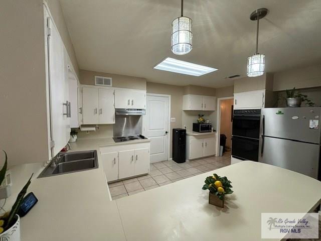 kitchen featuring visible vents, black appliances, a sink, under cabinet range hood, and light tile patterned flooring