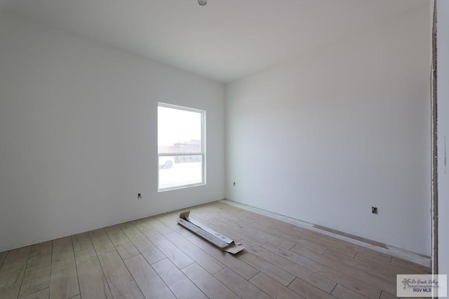 unfurnished room with light wood-type flooring