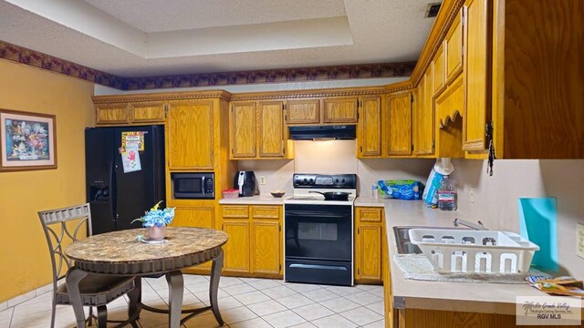 kitchen with electric range, brown cabinets, under cabinet range hood, built in microwave, and black refrigerator with ice dispenser