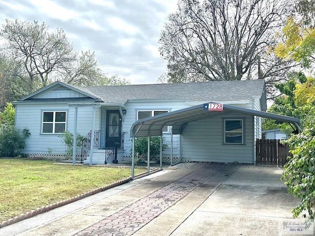 single story home with a front yard and a carport