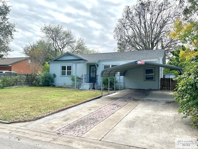 ranch-style house with a front yard and a carport