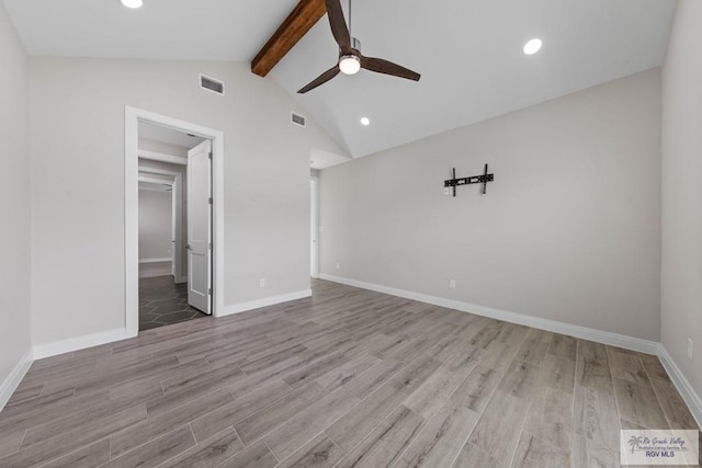 unfurnished room with visible vents, wood finished floors, ceiling fan, and lofted ceiling with beams
