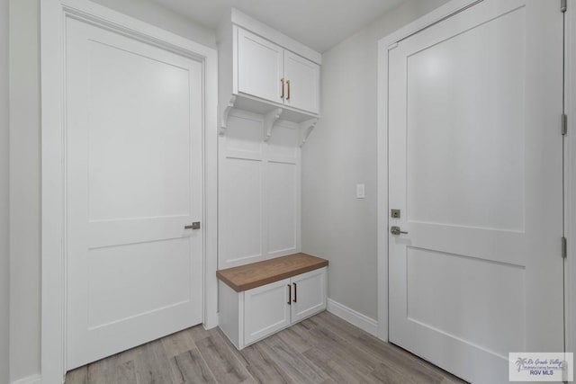 mudroom featuring baseboards and light wood-type flooring