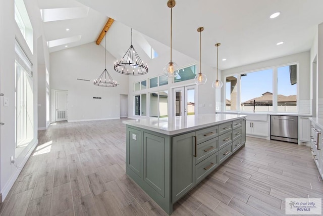 kitchen featuring gray cabinetry, light countertops, light wood-style floors, and dishwasher