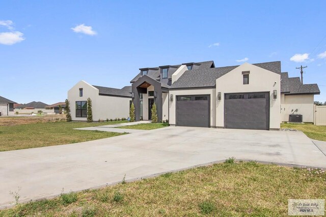 view of front of property featuring an attached garage, central AC, stucco siding, a front lawn, and driveway