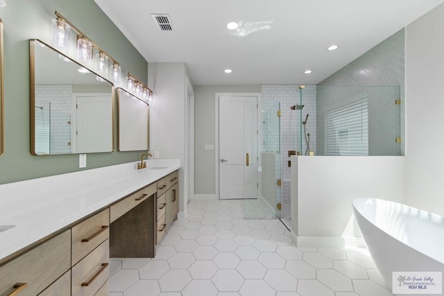 full bathroom with a stall shower, tile patterned floors, a sink, a soaking tub, and double vanity