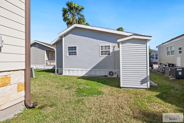 back of house with ac unit and a lawn