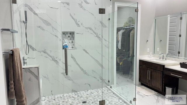 bathroom featuring vanity and a shower with door