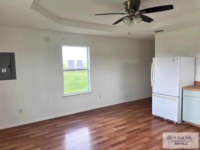 1056 E Mile 11, Weslaco, TX 78599 - kitchen featuring freestanding refrigerator, electric panel, wood finished floors, and a ceiling fan