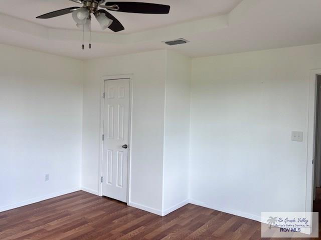 1056 E Mile 11, Weslaco, TX 78599 - unfurnished room with ceiling fan and dark wood finished floors