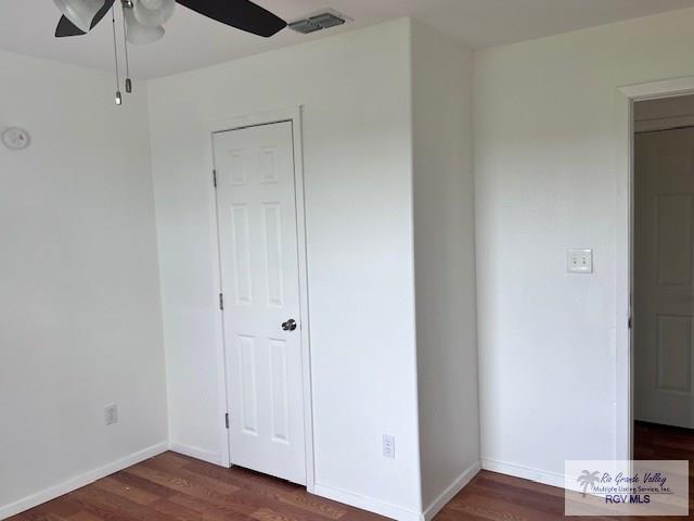 1056 E Mile 11, Weslaco, TX 78599 - unfurnished bedroom featuring wood finished floors and a ceiling fan
