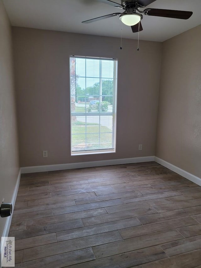 empty room featuring baseboards and wood finished floors
