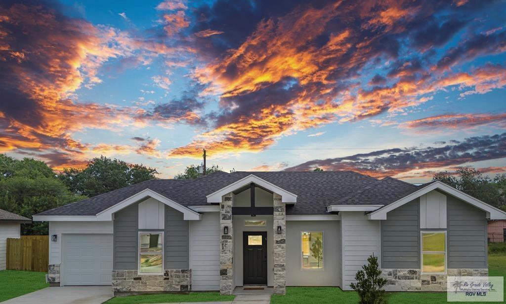 view of front of property with a lawn and a garage