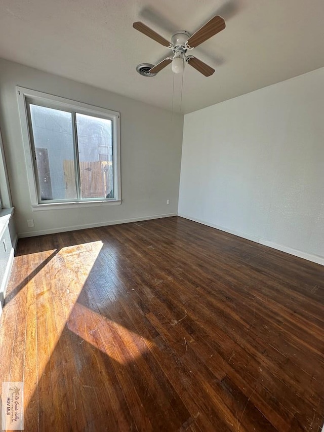 unfurnished room with ceiling fan and dark hardwood / wood-style floors