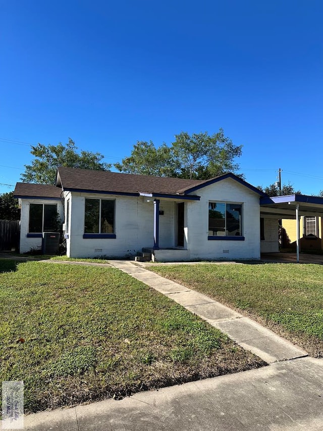 single story home featuring central air condition unit and a front yard