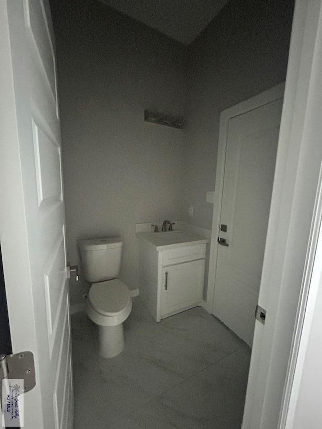 bathroom featuring tile patterned floors, toilet, and vanity