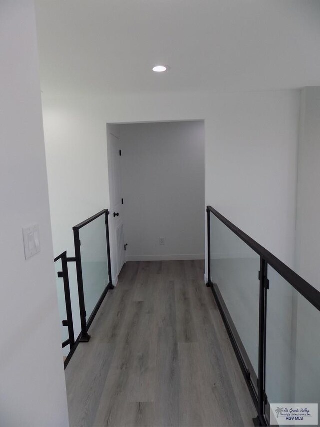 hall with hardwood / wood-style flooring