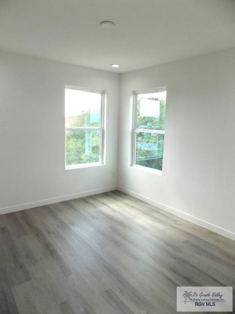 spare room featuring dark wood-type flooring