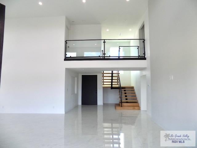 staircase with a towering ceiling