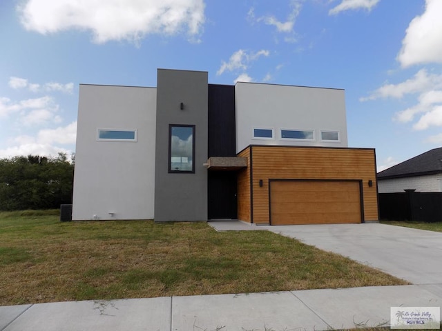 view of front of house with a front lawn and a garage