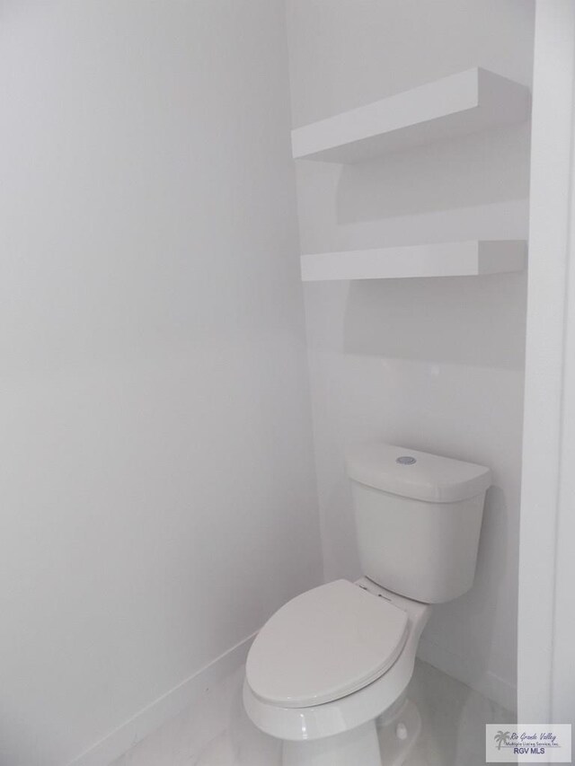 bathroom featuring tile patterned flooring and toilet