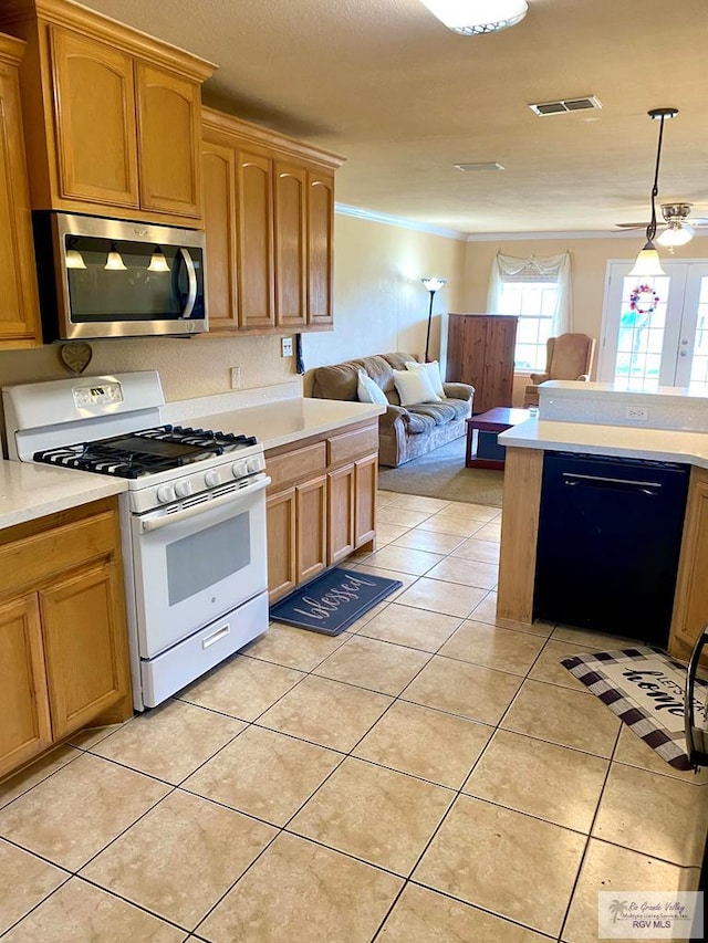 kitchen featuring white gas range oven, hanging light fixtures, black dishwasher, crown molding, and light tile patterned flooring