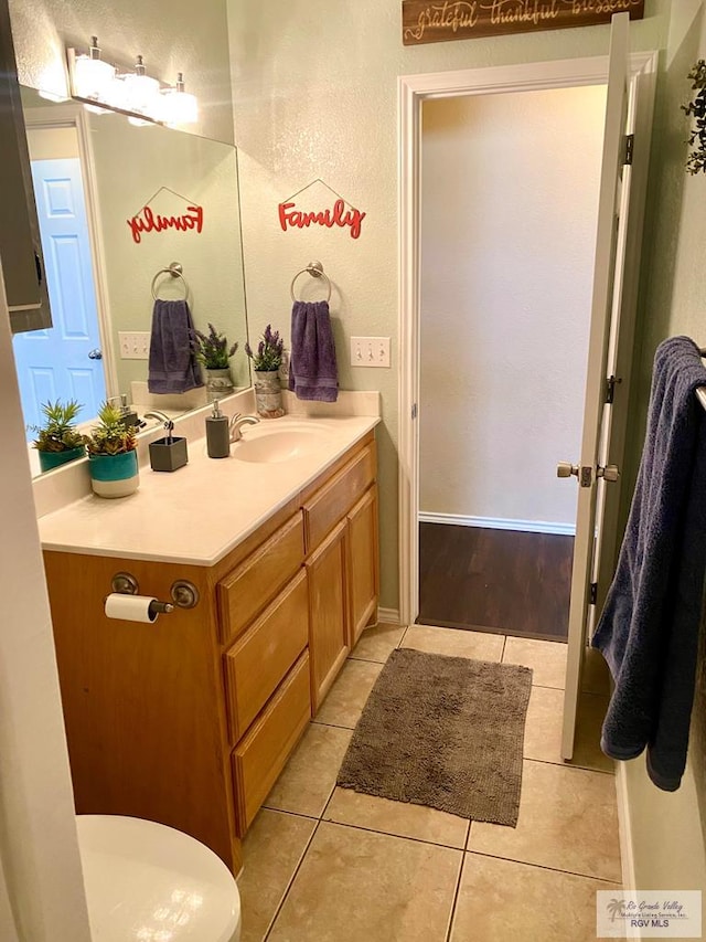 bathroom with tile patterned floors and vanity