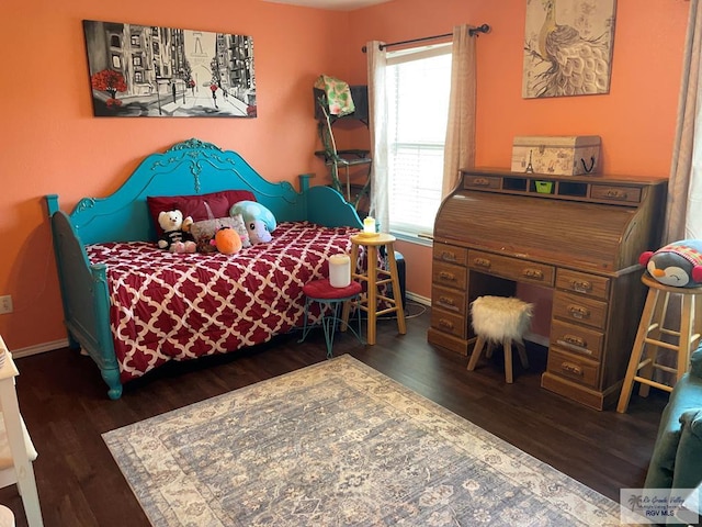 bedroom featuring dark hardwood / wood-style floors and multiple windows