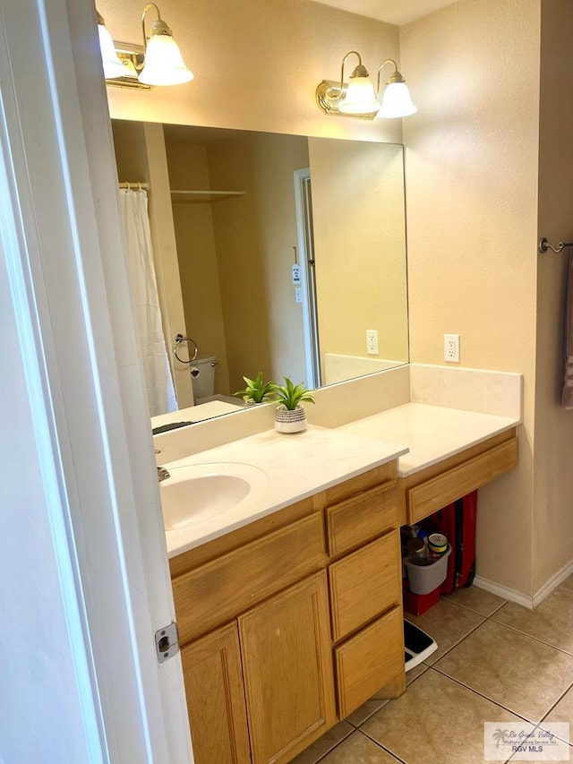 bathroom featuring tile patterned floors, toilet, vanity, and a shower with curtain