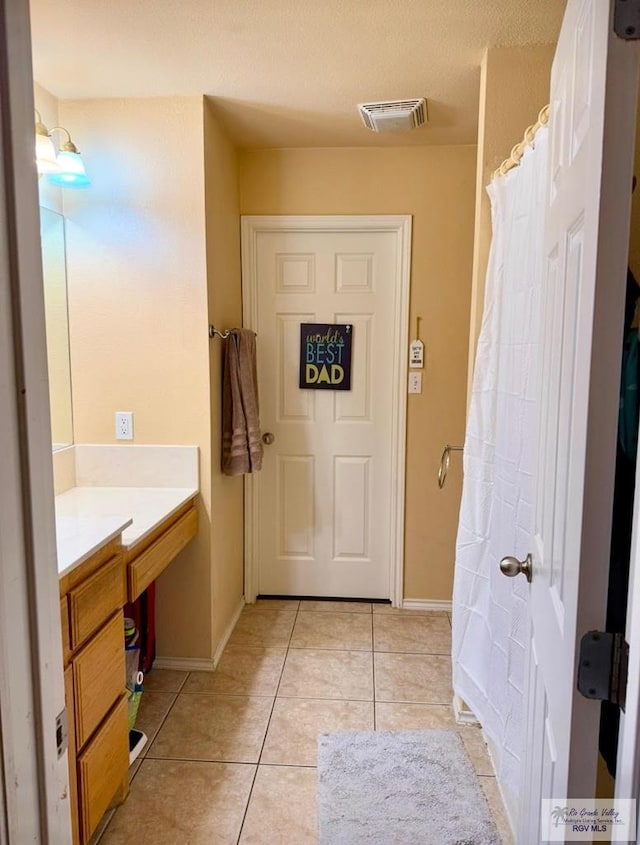 bathroom featuring vanity and tile patterned flooring