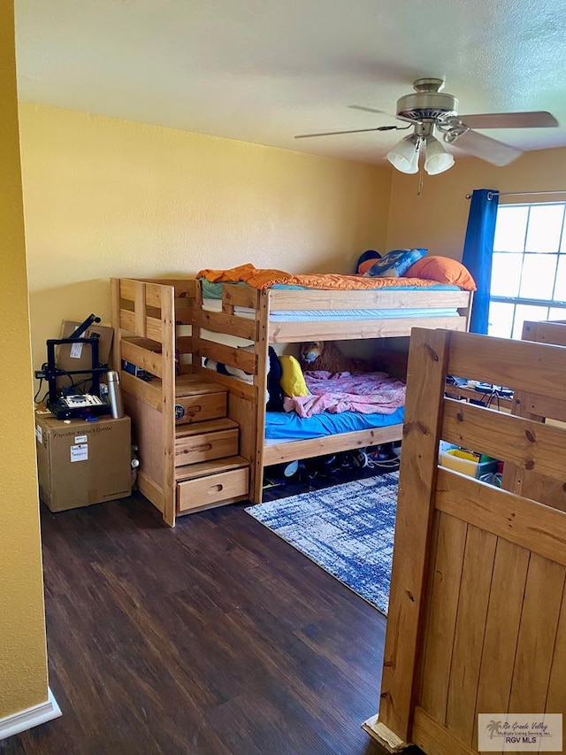 bedroom featuring ceiling fan and dark hardwood / wood-style flooring