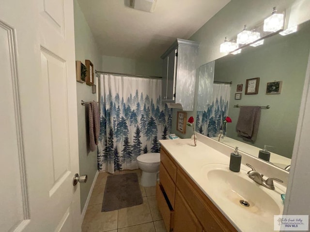 bathroom featuring toilet, vanity, and tile patterned flooring