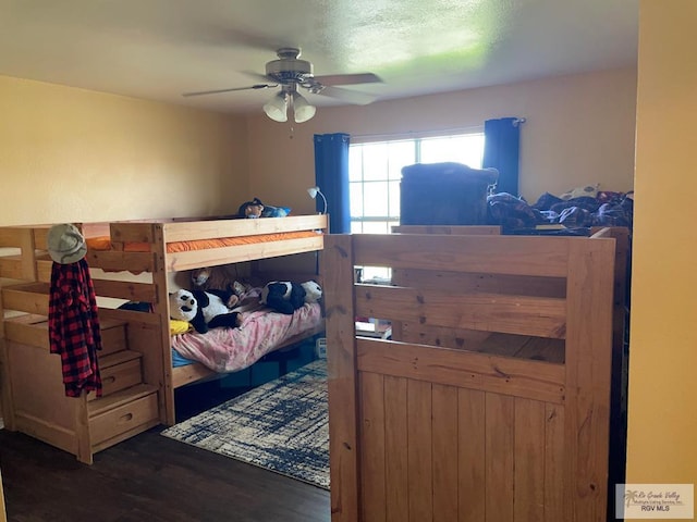 bedroom featuring ceiling fan and dark hardwood / wood-style floors