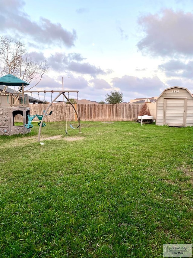 view of yard with a playground and a storage shed