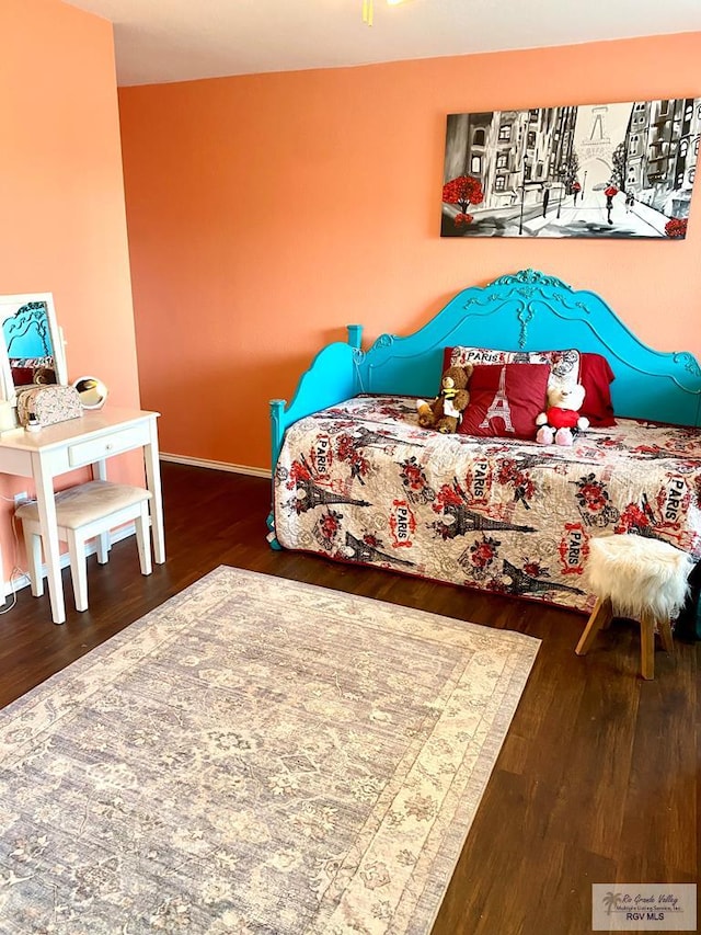 bedroom with dark wood-type flooring