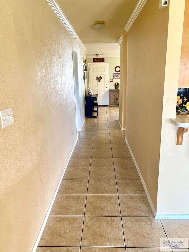 corridor featuring tile patterned flooring and ornamental molding