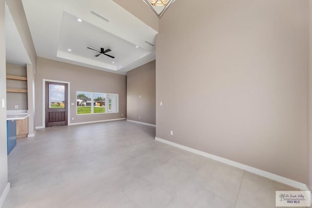 unfurnished room with a tray ceiling and ceiling fan