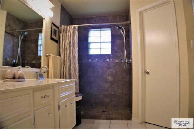 bathroom with tile patterned floors, curtained shower, and vanity