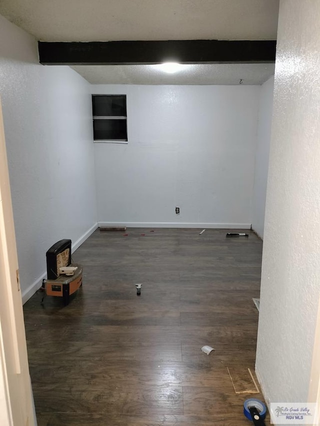 basement with dark hardwood / wood-style flooring