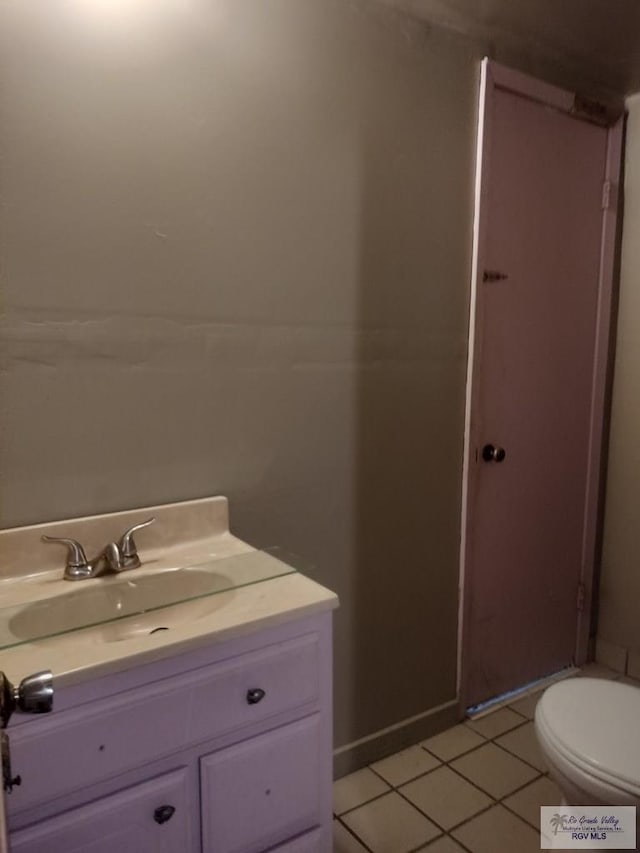 bathroom with tile patterned floors, vanity, and toilet