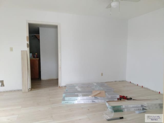 empty room with ceiling fan and light wood-type flooring