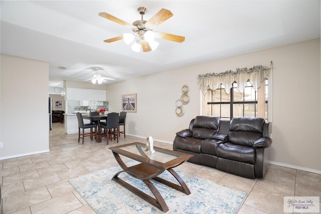 living room with light tile patterned floors and ceiling fan