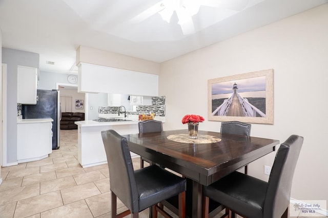 tiled dining area with ceiling fan