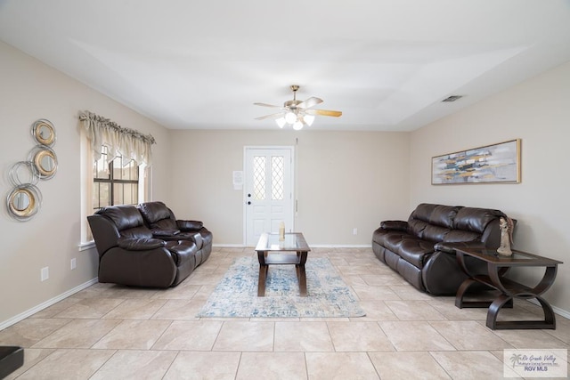 living room with ceiling fan, light tile patterned floors, and a healthy amount of sunlight