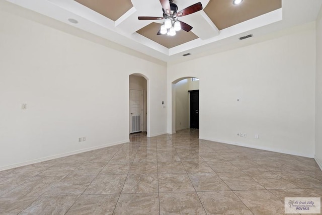 empty room featuring ceiling fan, beam ceiling, and coffered ceiling