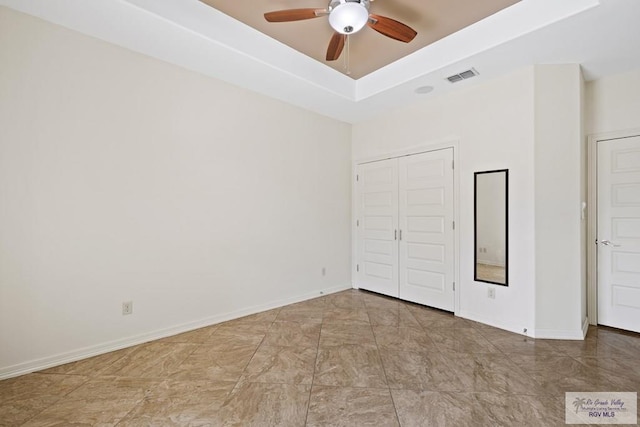 unfurnished bedroom with ceiling fan and a closet