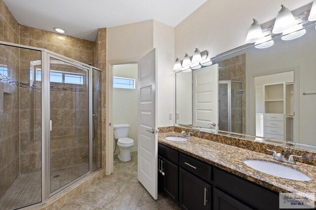 bathroom with vanity, toilet, and walk in shower