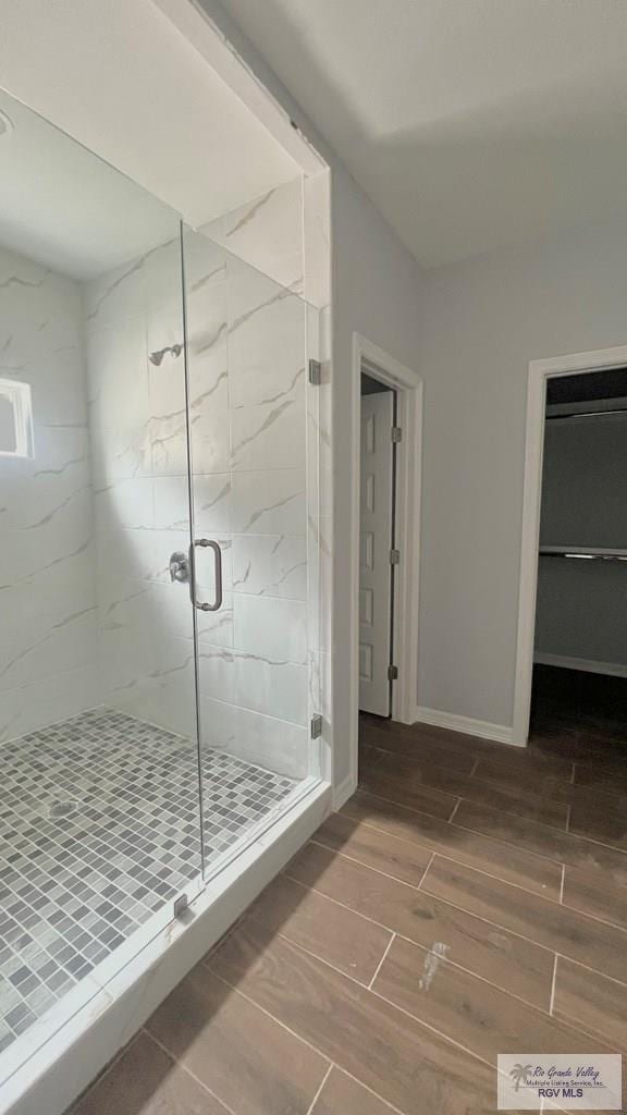 2517 S Christian Cir, Harlingen, TX 78550 - bathroom featuring wood finish floors and a marble finish shower