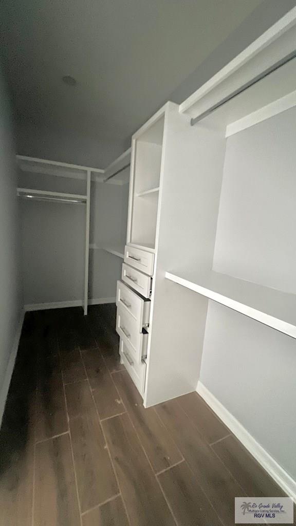 2517 S Christian Cir, Harlingen, TX 78550 - spacious closet with dark wood finished floors