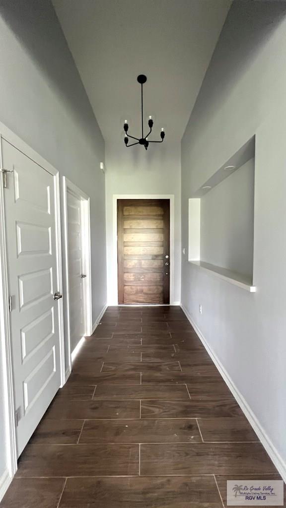 2517 S Christian Cir, Harlingen, TX 78550 - hall with a chandelier and dark wood-type flooring
